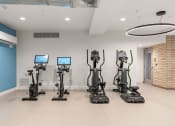 Thumbnail 39 of 84 - a group of exercise machines in a room at The Revival, Utah, 84101