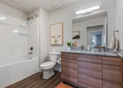 Thumbnail 130 of 136 - a bathroom with a toilet and a tub and a sink at The Flats at Riverwoods, Provo