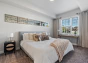 Thumbnail 124 of 136 - a bedroom with a large bed and a window at The Flats at Riverwoods, Provo, UT, 84604