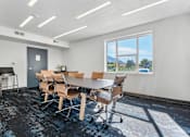 Thumbnail 58 of 136 - a conference room with a table and chairs and a window at The Flats at Riverwoods, Provo, 84604