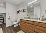 Thumbnail 126 of 136 - a bathroom with a toilet and a sink and a mirror at The Flats at Riverwoods, Provo, Utah