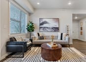 Thumbnail 113 of 136 - a living room with a couch and a coffee table at The Flats at Riverwoods, Provo, Utah