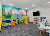 Thumbnail 64 of 136 - a play room with chairs and toys and a wall mural at The Flats at Riverwoods, Provo, UT