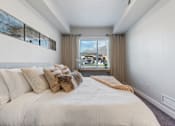Thumbnail 115 of 136 - a bedroom with a large bed and a window at The Flats at Riverwoods, Provo, UT