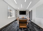 Thumbnail 30 of 136 - a conference room with a table and chairs and a tv on the wall at The Flats at Riverwoods, Provo, UT, 84604