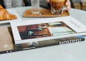 Thumbnail 10 of 55 - A person is sitting at a table with a glass of coffee at Bautista Apartments, Tucson, 85745