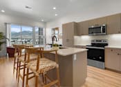 Thumbnail 54 of 144 - A kitchen with wooden chairs and a counter.