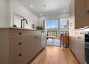 Thumbnail 55 of 144 - A kitchen with wooden cabinets and a black faucet.