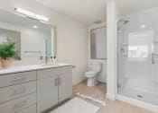 Thumbnail 27 of 131 - a white bathroom with a toilet and a shower at Paperbox Lofts, Salt Lake City, 84101