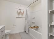 Thumbnail 90 of 131 - a bathroom with a shower and a toilet and a sink at Paperbox Lofts, Salt Lake City, UT