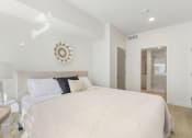 Thumbnail 23 of 131 - a bedroom with a large bed and a bathroom at Paperbox Lofts, Salt Lake City