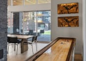 Thumbnail 62 of 131 - a long wooden table in a room with a large window at Paperbox Lofts, Salt Lake City, 84101