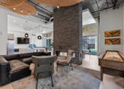 Thumbnail 59 of 131 - a living room with couches and chairs and a pool table at Paperbox Lofts, Utah