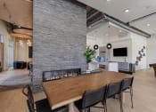 Thumbnail 58 of 131 - a living room with a fireplace and a wooden table at Paperbox Lofts, Salt Lake City, UT