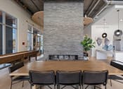 Thumbnail 60 of 131 - a dining room with a table and chairs in front of a fireplace at Paperbox Lofts, Utah, 84101