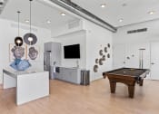 Thumbnail 54 of 131 - a living room with a pool table and a tv