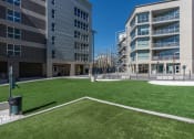 Thumbnail 121 of 131 - a lawn in front of a building with grass at Paperbox Lofts, Salt Lake City, Utah