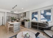Thumbnail 16 of 131 - a living room with a kitchen and a dining table at Paperbox Lofts, Utah, 84101