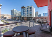 Thumbnail 92 of 131 - a balcony with a view of a city and some buildings at Paperbox Lofts, Salt Lake City, UT, 84101