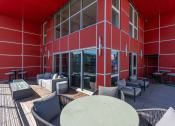 Thumbnail 108 of 131 - a large red building with tables and chairs outside of it at Paperbox Lofts, Salt Lake City, UT, 84101