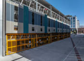 Thumbnail 99 of 131 - the side of a building with a yellow barricade and a blue and white facade at Paperbox Lofts, Salt Lake City, Utah
