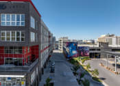 Thumbnail 105 of 131 - an aerial view of a city street with buildings and street art at Paperbox Lofts, Utah