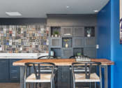 Thumbnail 53 of 131 - a dining room with tables and chairs and blue walls at Paperbox Lofts, Salt Lake City, UT