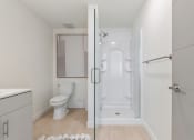 Thumbnail 30 of 131 - a bathroom with a toilet and a glass shower at Paperbox Lofts, Salt Lake City, UT, 84101