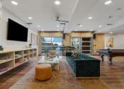 Thumbnail 33 of 84 - a living room with a green couch and a pool table at The Revival, Utah, 84101