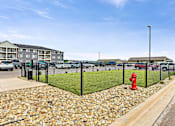 Thumbnail 49 of 74 - a view of a dog park with a red fire hydrant in front at Red Rock Apartments, Rapid City, 57702