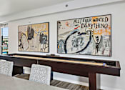 Thumbnail 44 of 74 - a room with a pool table and two paintings on the wall at Red Rock Apartments, Rapid City