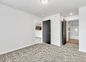 Thumbnail 68 of 74 - a bedroom with grey carpet and white walls at Red Rock Apartments, Rapid City, SD