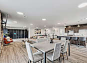 Thumbnail 2 of 74 - a living room and kitchen area with a dining table and chairs at Red Rock Apartments, South Dakota 57702