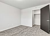 Thumbnail 69 of 74 - a bedroom with gray carpet and a closet with a black door at Red Rock Apartments, South Dakota 57702