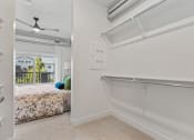Thumbnail 80 of 84 - an empty bedroom with a bed and a closet with a sliding glass door at The Revival, Utah, 84101