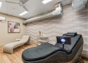 Thumbnail 52 of 84 - a spa room with a massage bed and a massage chair at The Revival, Salt Lake City, Utah