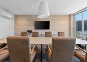 Thumbnail 46 of 84 - a conference room with a table and chairs and a tv on the wall at The Revival, Salt Lake City, UT, 84101