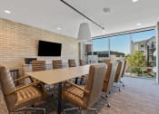 Thumbnail 47 of 84 - a conference room with a long table and chairs and a large window at The Revival, Salt Lake City, Utah