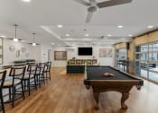 Thumbnail 29 of 84 - a game room with a pool table and a bar with chairs at The Revival, Salt Lake City, Utah