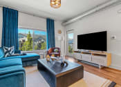 Thumbnail 70 of 84 - a living room with blue couches and a tv at The Revival, Salt Lake City, Utah