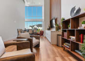 Thumbnail 61 of 84 - a living room filled with furniture and a large window at The Revival, Salt Lake City, Utah