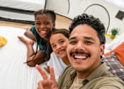 Thumbnail 24 of 61 - A man and two children are taking a selfie at Bautista Apartments, Tucson
