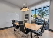 Thumbnail 121 of 126 - a conference room with a wooden table and chairs at SevenO2 Main Apartments, Salt Lake City, 84101