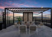Thumbnail 118 of 126 - a patio with a table and chairs under a pergola at SevenO2 Main Apartments, Salt Lake City, Utah