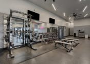 Thumbnail 87 of 126 - a gym with weights and dumbbells and other exercise equipment at SevenO2 Main Apartments, Salt Lake City, 84101