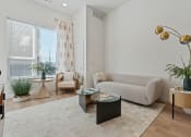 Thumbnail 76 of 126 - a living room with a couch and a table at SevenO2 Main Apartments, Utah, 84101
