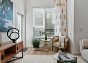 Thumbnail 68 of 126 - a living room with a couch and a table and a window at SevenO2 Main Apartments, Salt Lake City, 84101