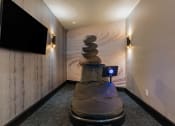 Thumbnail 82 of 126 - a massage chair in a room with a wall mural and a tv at SevenO2 Main Apartments, Utah, 84101