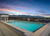 Thumbnail 84 of 126 - a pool on the roof of a building with mountains in the background at SevenO2 Main Apartments, Salt Lake City, UT, 84101