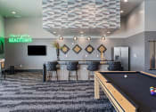 Thumbnail 80 of 126 - a game room with a pool table and a bar at SevenO2 Main Apartments, Salt Lake City, UT, 84101